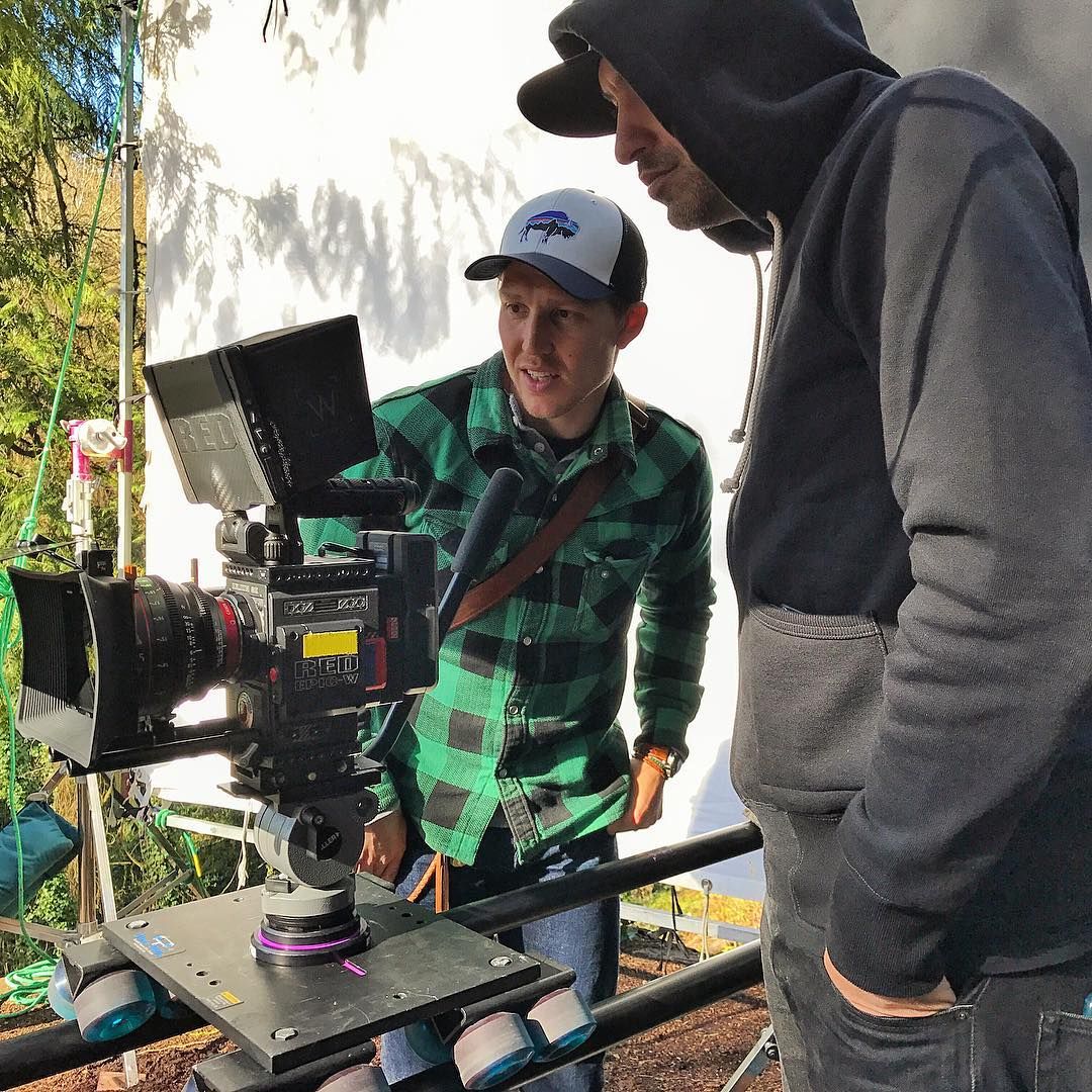 Director Devin Leisher (green shirt) and 1st AD Erik Motta (hoodie) with the Epic-W on the dolly during a Portland setup