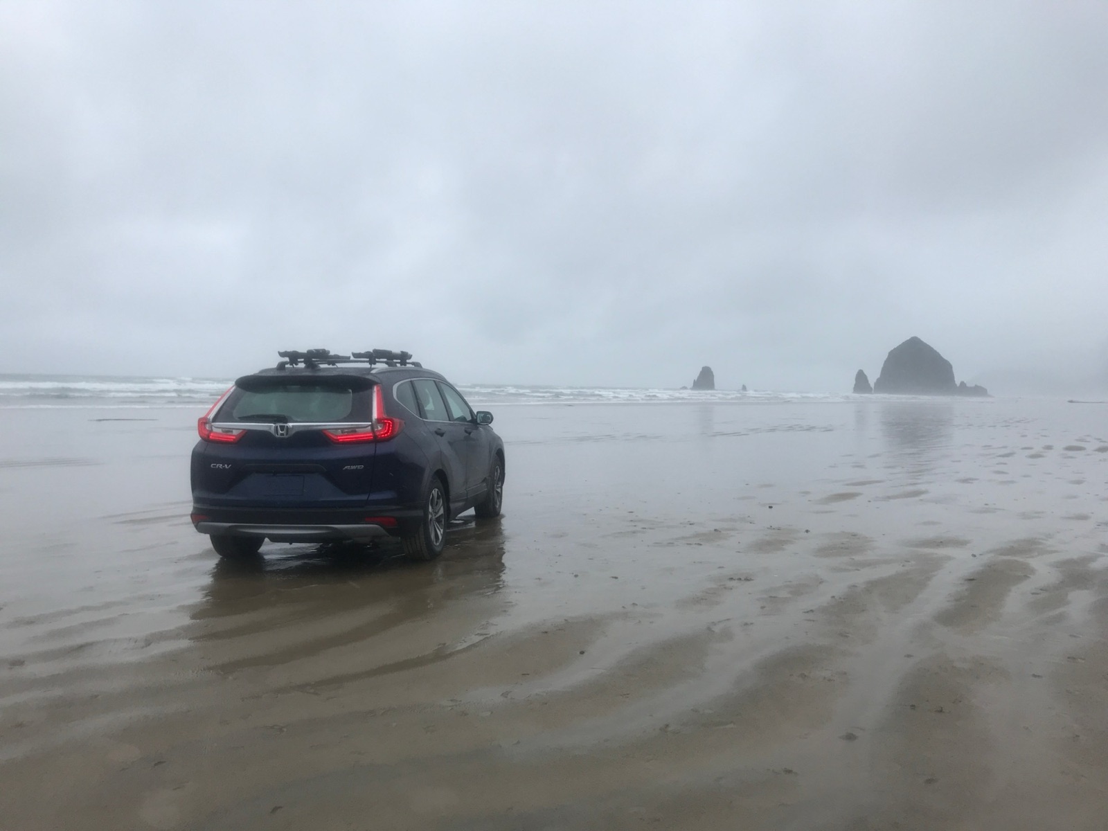 CR-V: the hero car on the wet sand at Cannon Beach, Haystack Rock behind