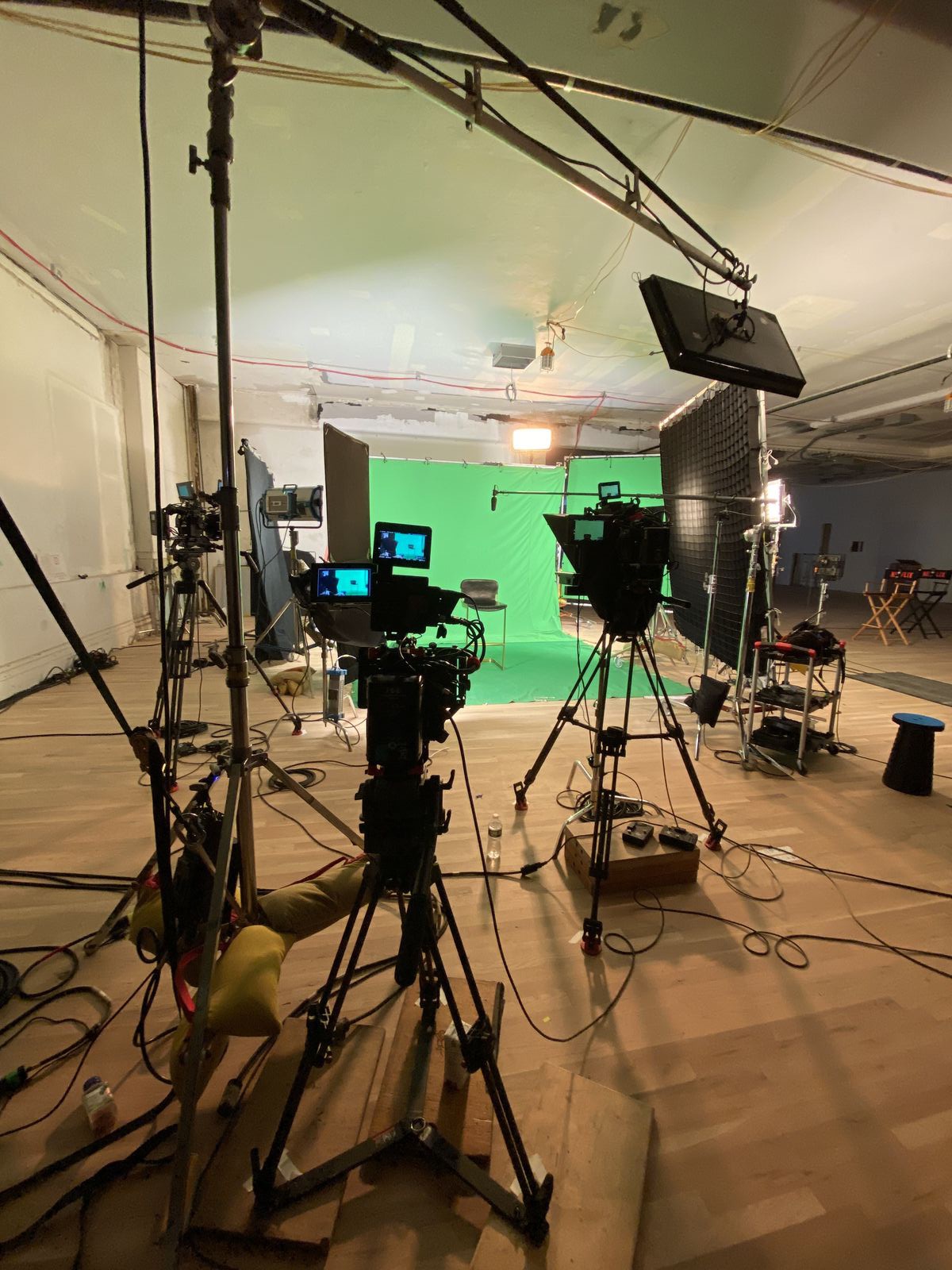 behind the C300s on tripods aimed at the green screen