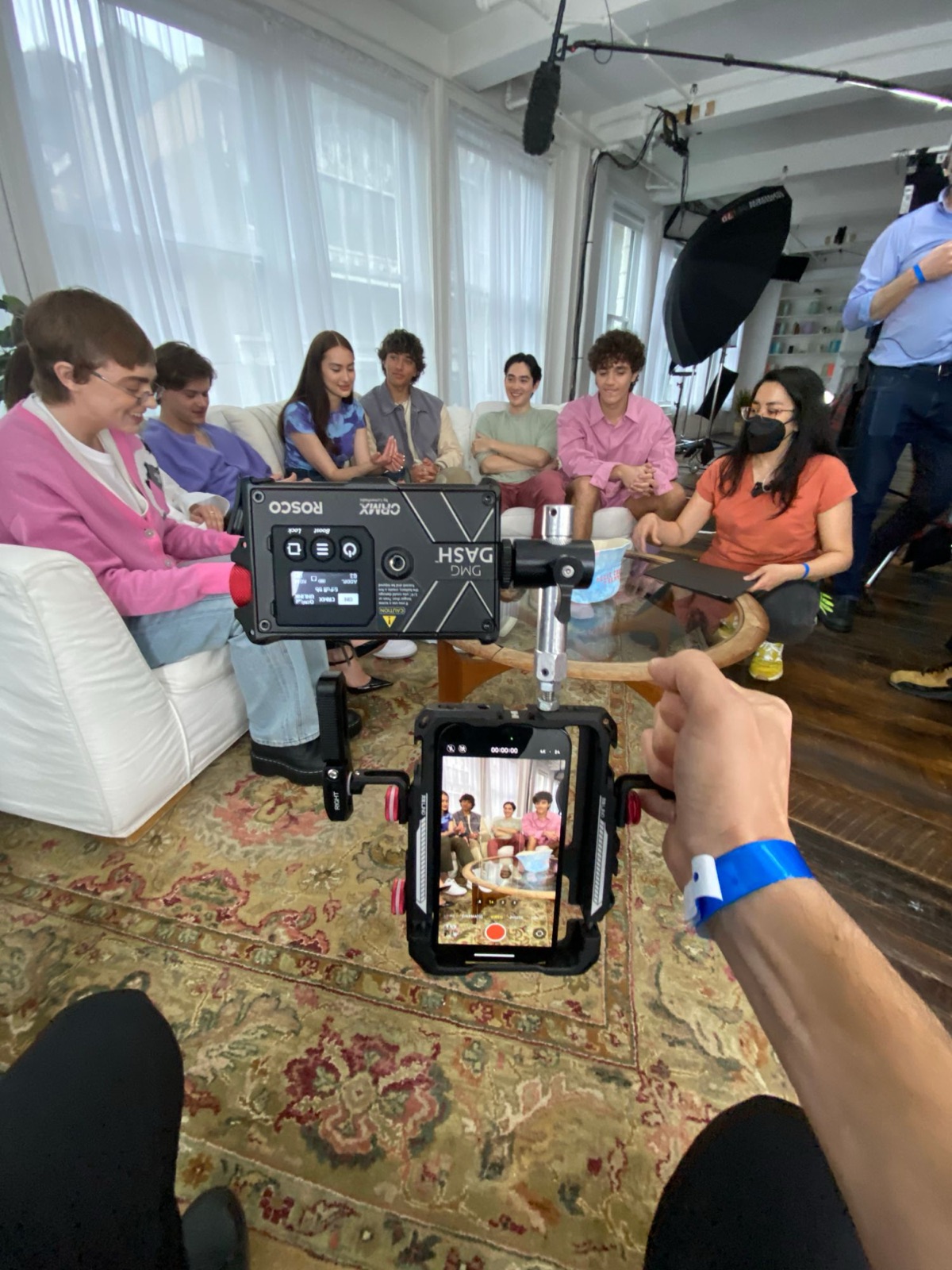 The cast on the sofa, shot on the phone rig with a Rosco DMG Dash on top