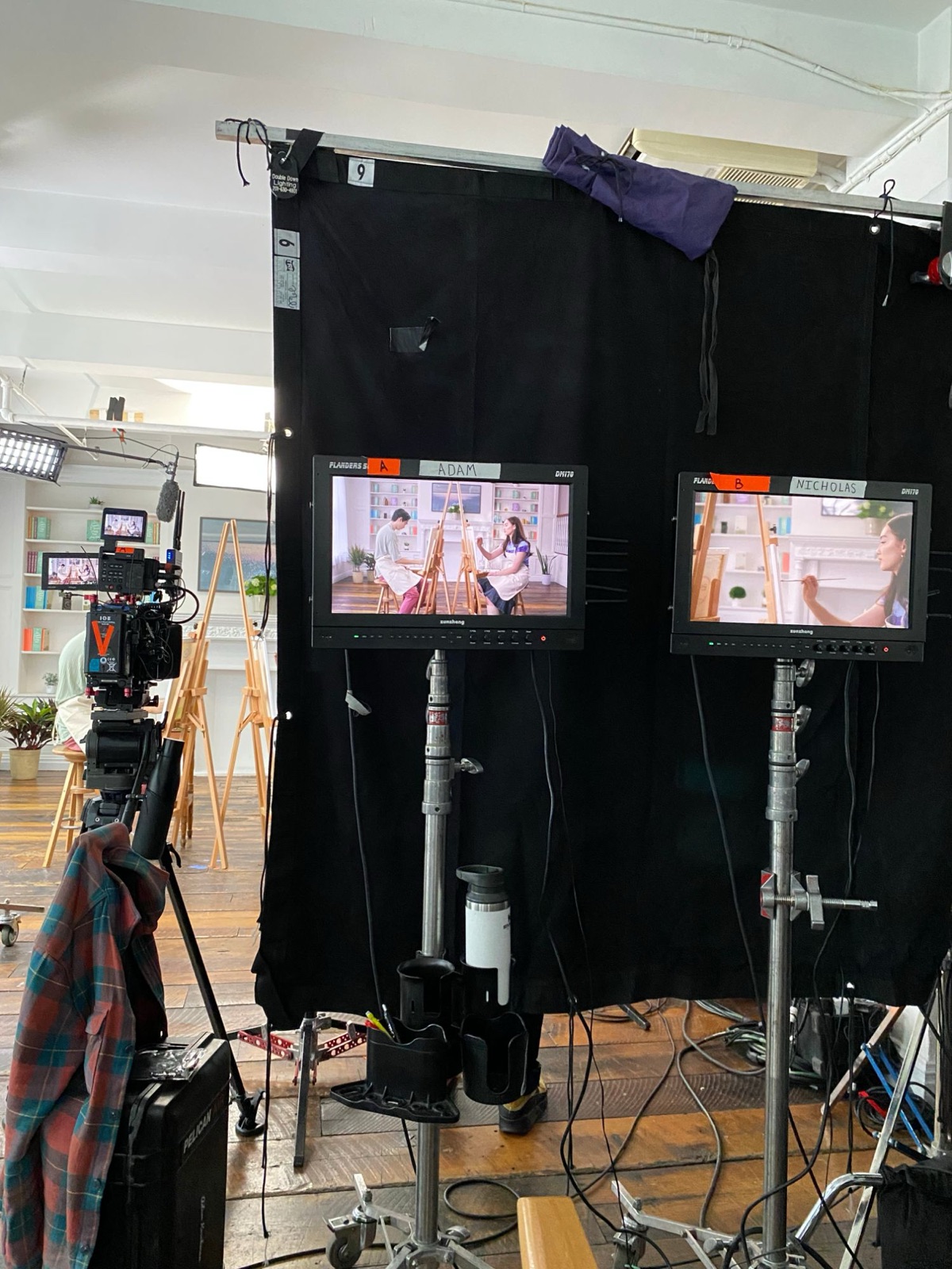 A and B camera monitors on the portrait-painting setup
